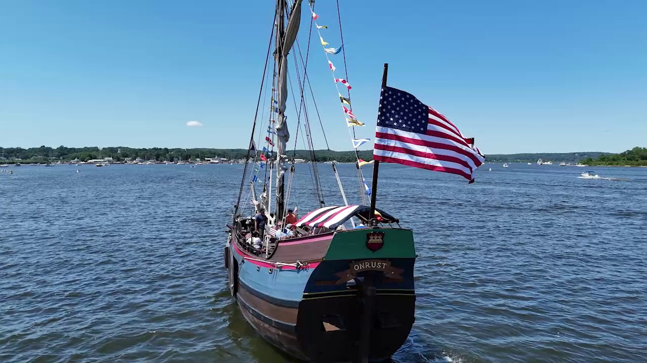 Essex boat parade on the Connecticut River with a large American flag