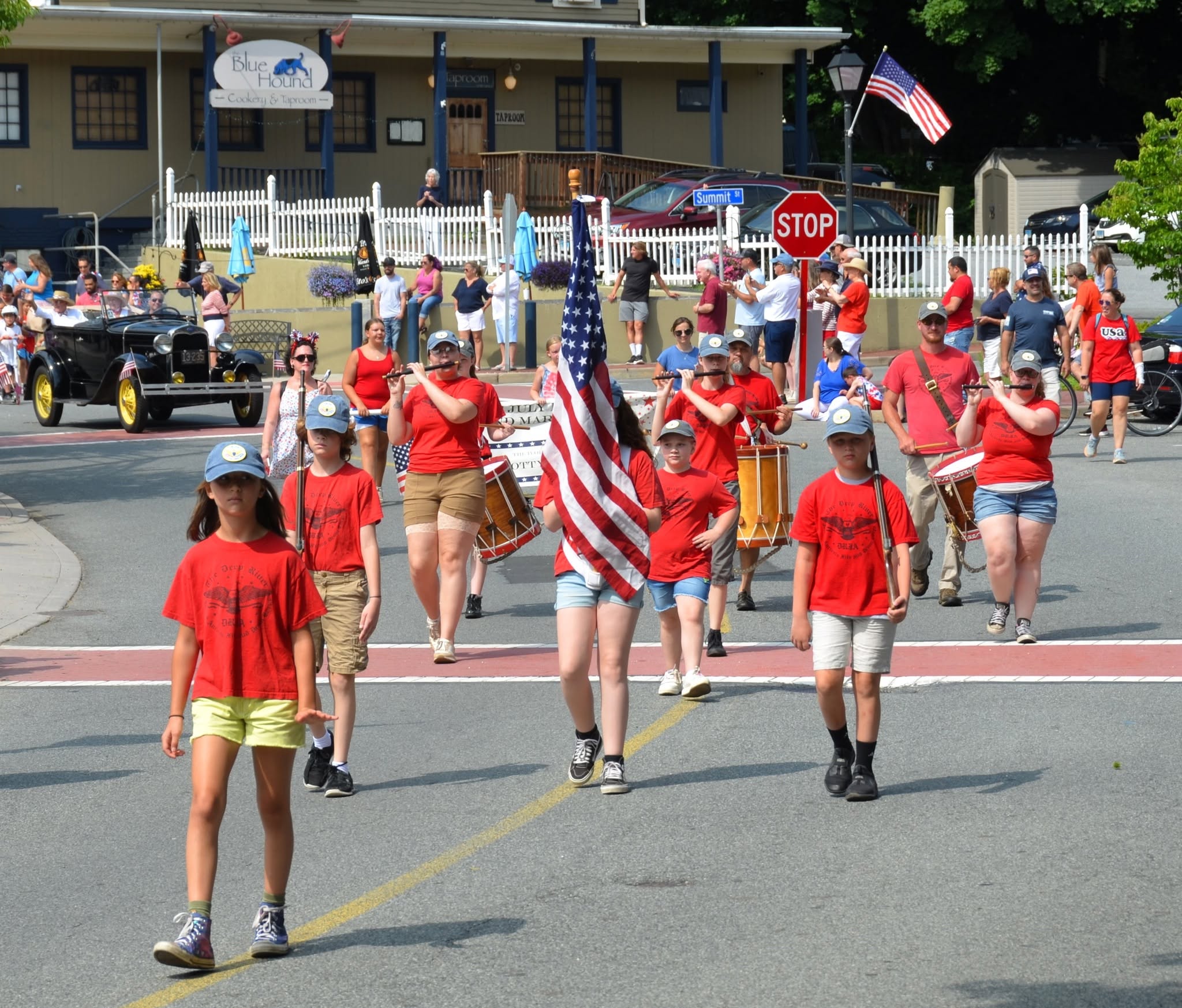 Ivoryton land parade with marchers, flags, and spectators